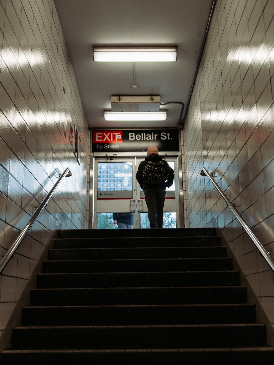 A man stands at the Bellair St. exit of a Toronto subway station, ready to step into the city streets.