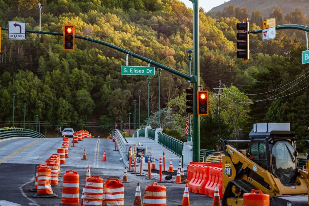Busy road construction scene with traffic lights and signage on S. Eliseo Dr.