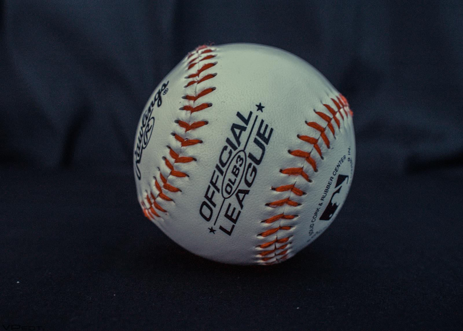 Detailed close-up of an official league baseball with visible branding and stitches.
