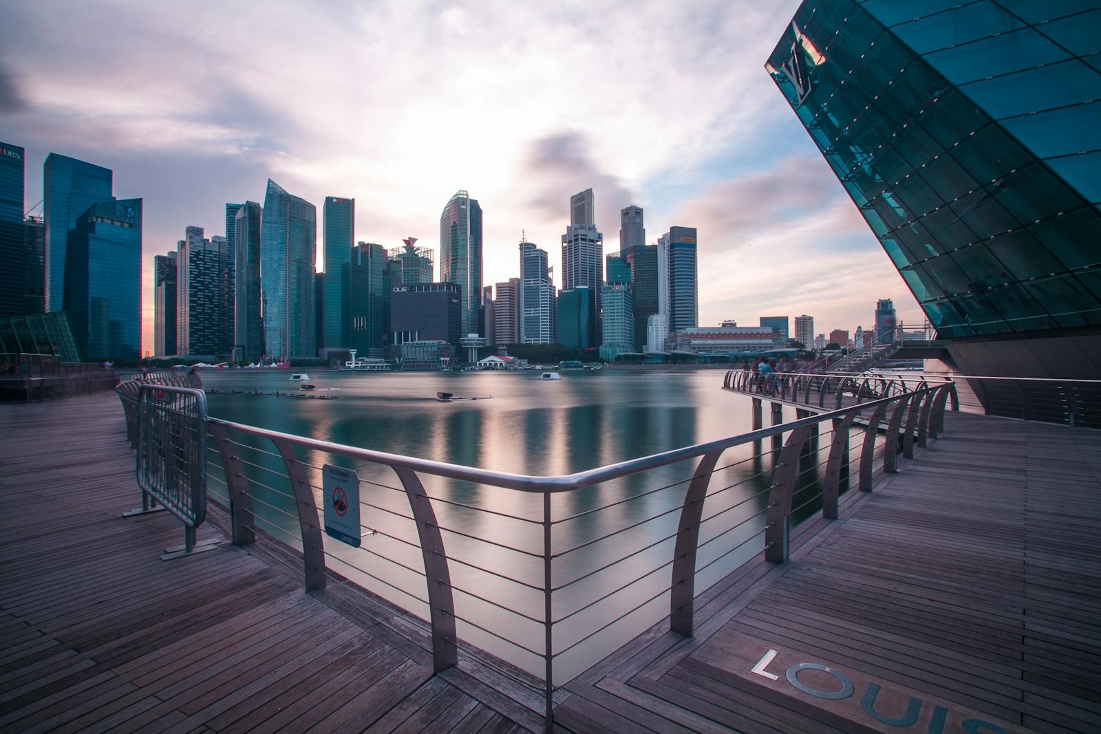 Breathtaking view of Singapore's modern skyline reflecting on the water at twilight.