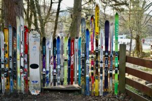 A vibrant display of skis and snowboards outdoors in Aviemore Centre, Scotland.