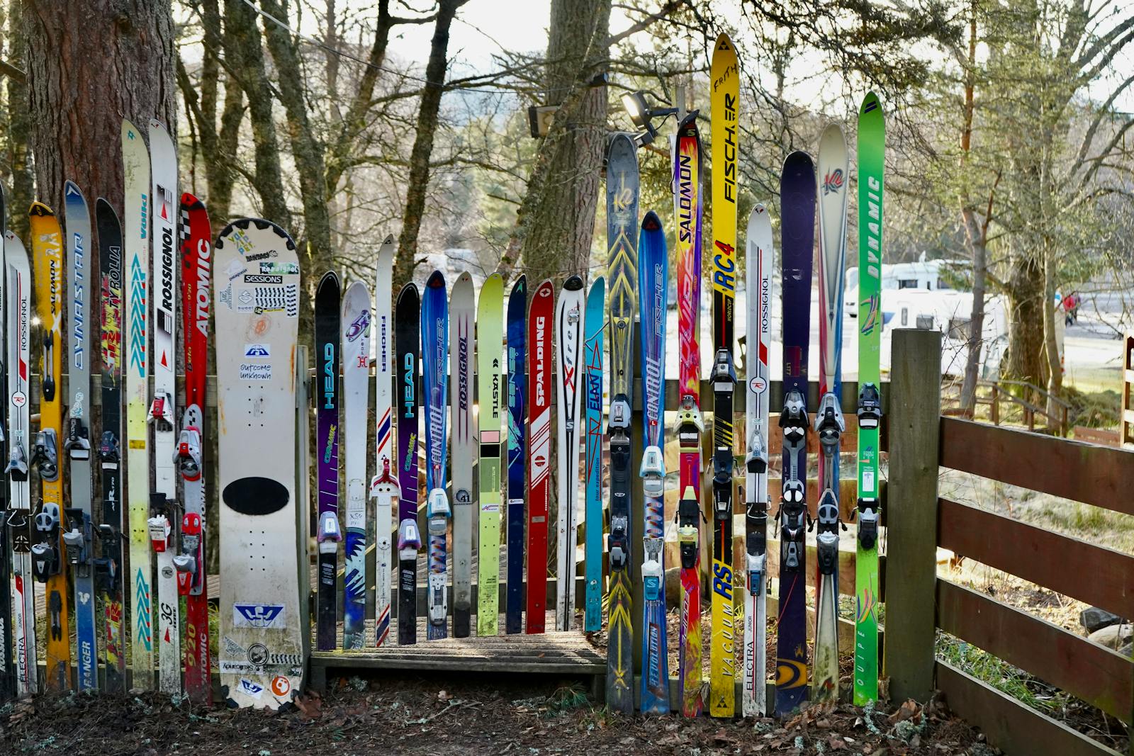 A vibrant display of skis and snowboards outdoors in Aviemore Centre, Scotland.