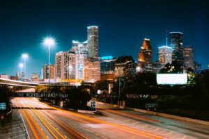 Captivating view of Houston's skyline at night with light trails and illuminated buildings.
