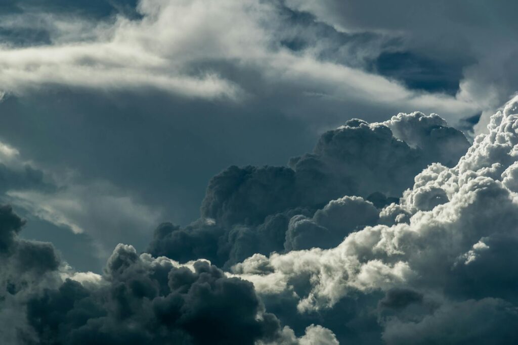 A powerful depiction of dark, dramatic clouds covering the sky, showcasing the majestic beauty of nature.