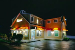 A Dunkin' Donuts storefront illuminated at night in Stamford, Connecticut.