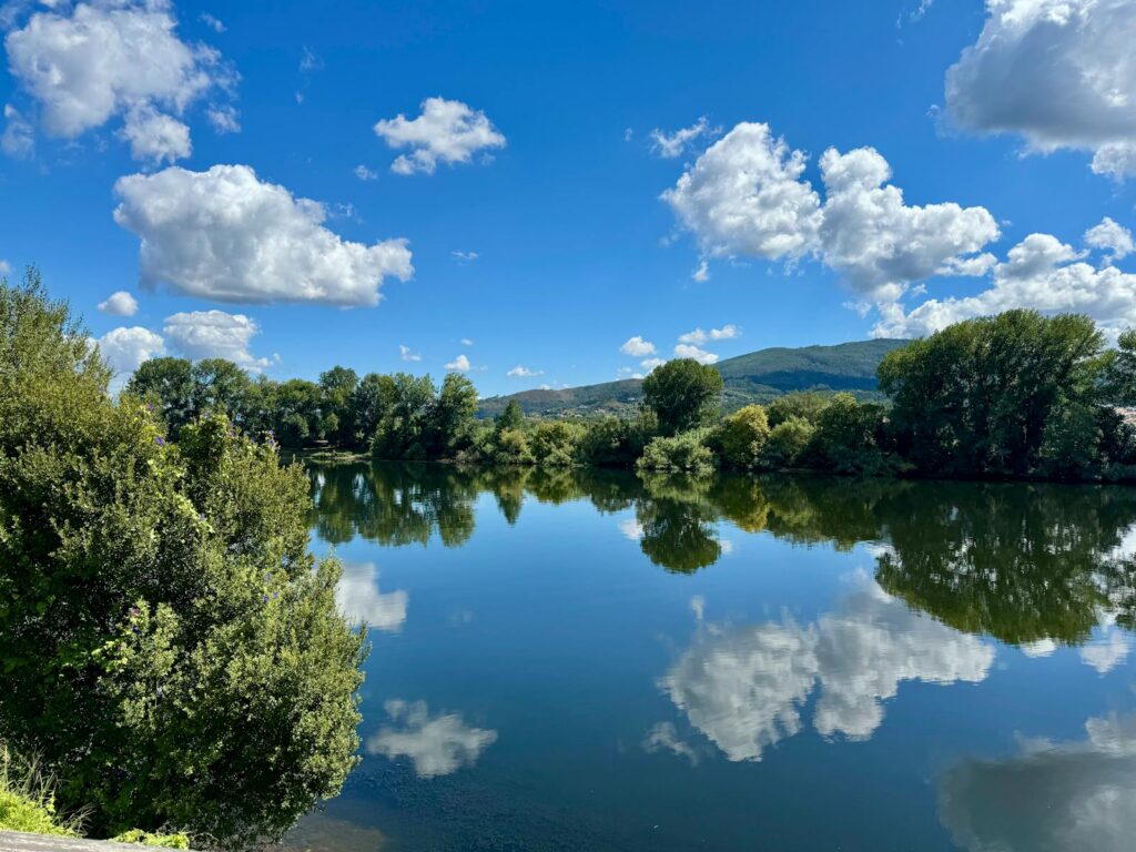Beautiful river with clear reflections and blue sky, perfect for nature lovers.