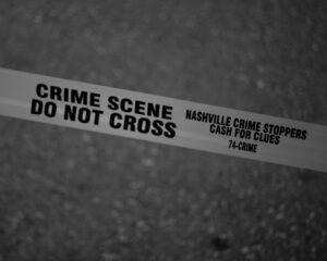 Black and white close-up of crime scene tape with Nashville text.