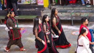 People in traditional clothing walking outdoors.