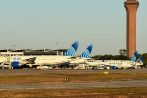 A row of airplanes parked at an airport